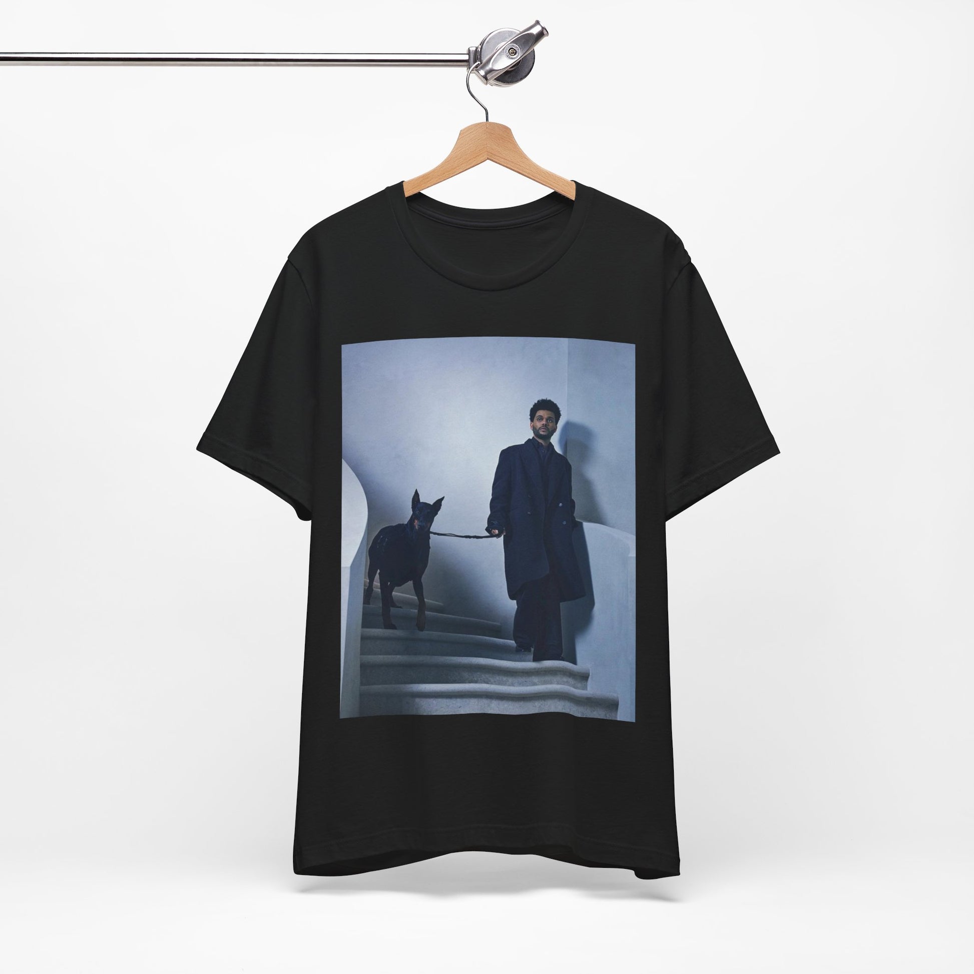 A black graphic t-shirt featuring a photo of The Weeknd with a doberman.