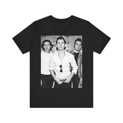 A black graphic t-shirt featuring a vintage-style design related to Arctic Monkeys' 'AM' album era, possibly with the album art or band imagery.