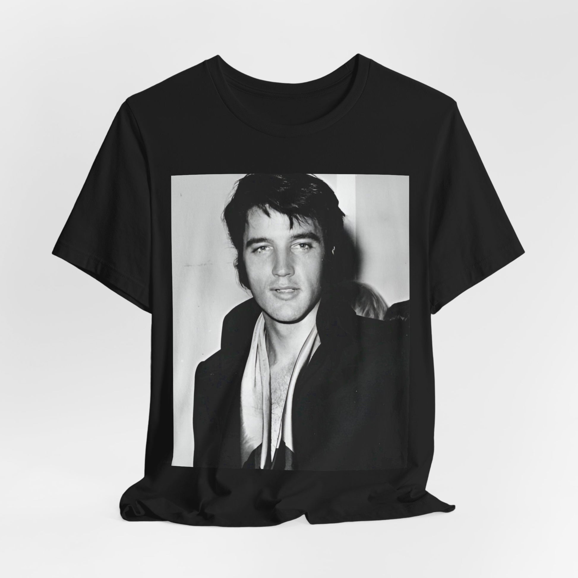 A black graphic t-shirt featuring a black and white rock and roll portrait photo of Elvis Presley.