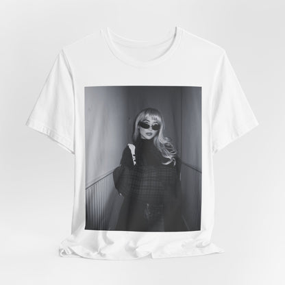A black graphic t-shirt featuring a black and white glam pop diva graphic of Sabrina Carpenter.