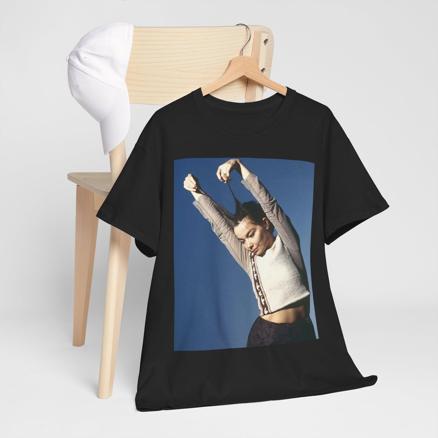 A black graphic t-shirt featuring a graphic of Bjork, designed with a futuristic or timeless aesthetic, labeling it a 'future classic'.
