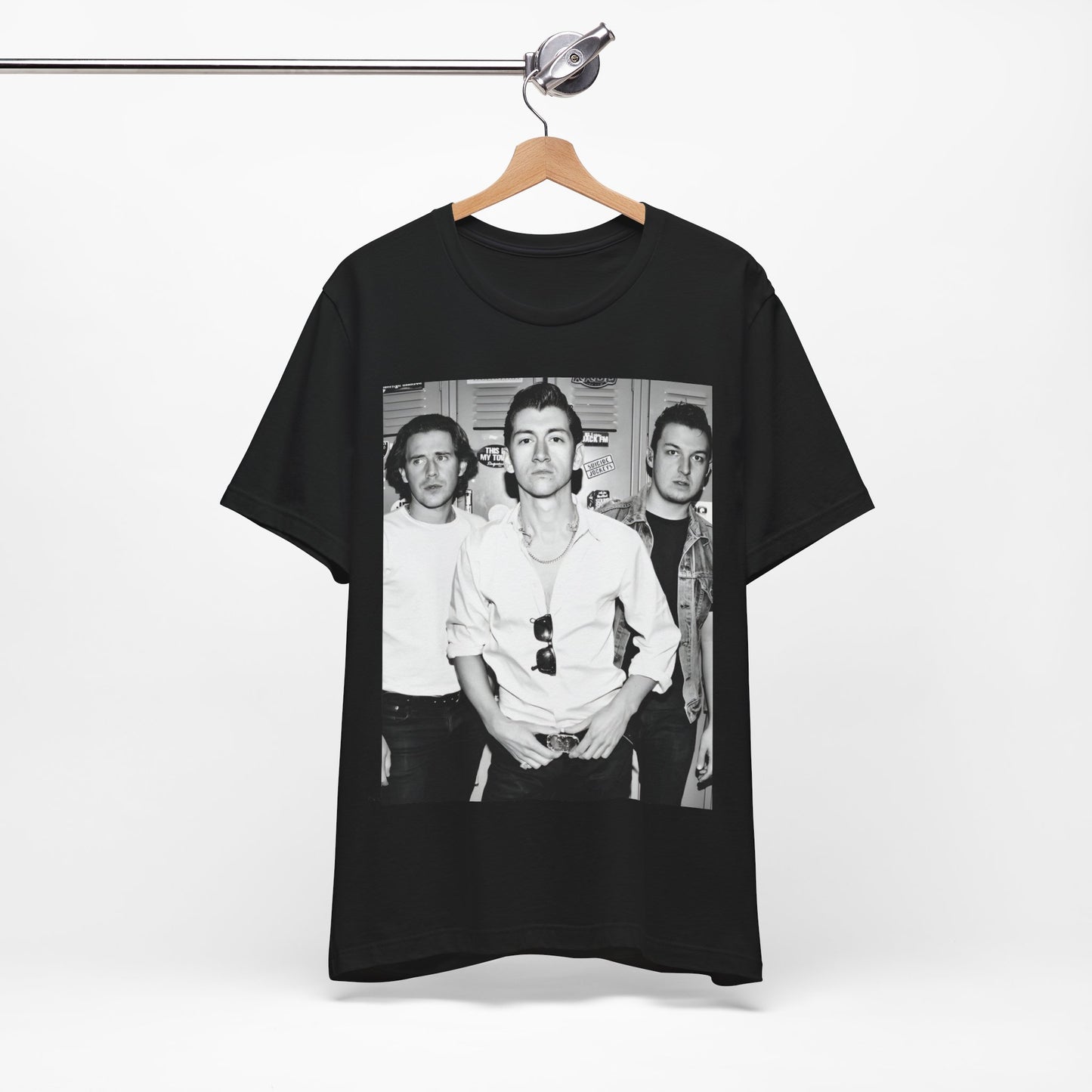 A black graphic t-shirt featuring a vintage-style design related to Arctic Monkeys' 'AM' album era, possibly with the album art or band imagery.