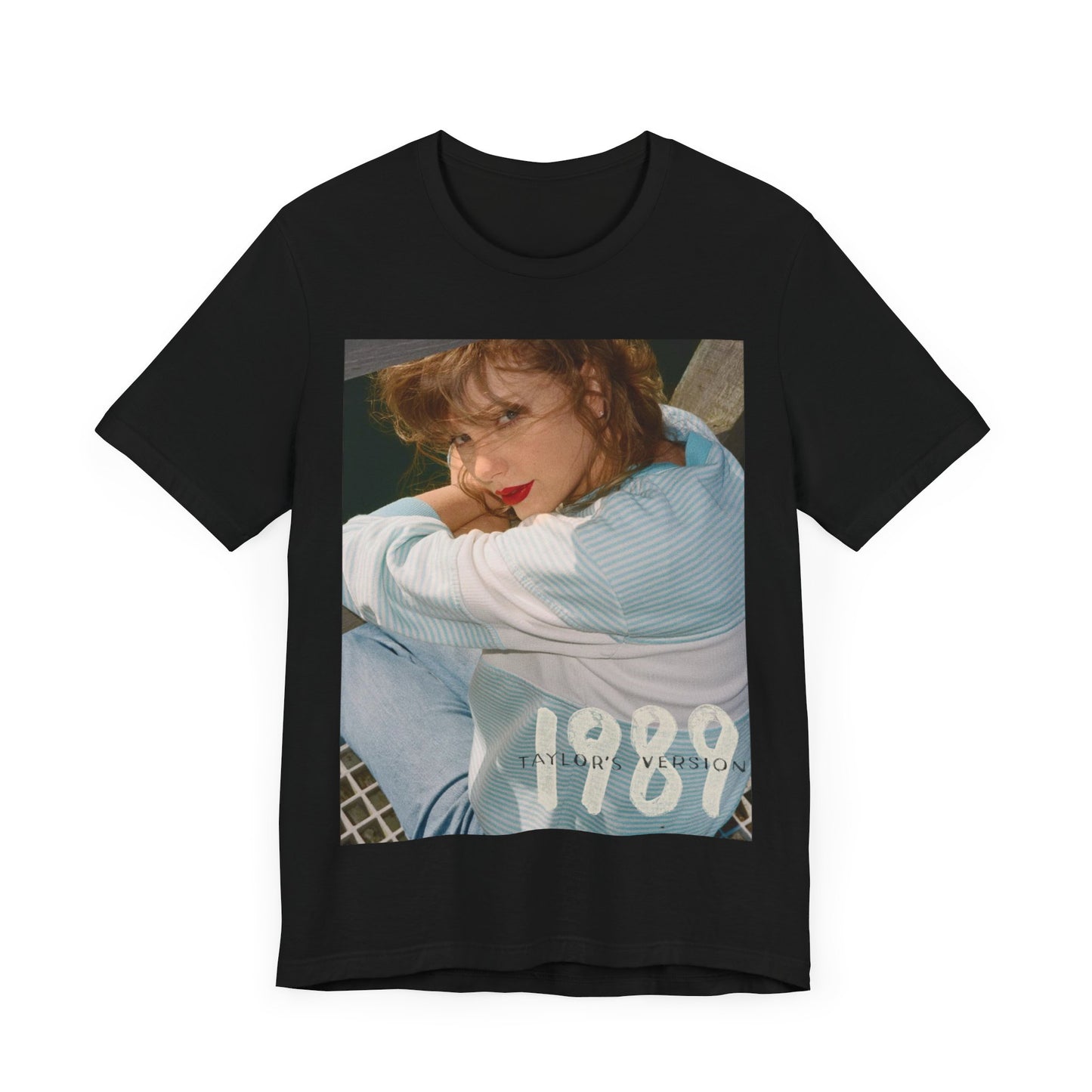 A black graphic t-shirt featuring a 1989 aesthetic graphic of Taylor Swift.