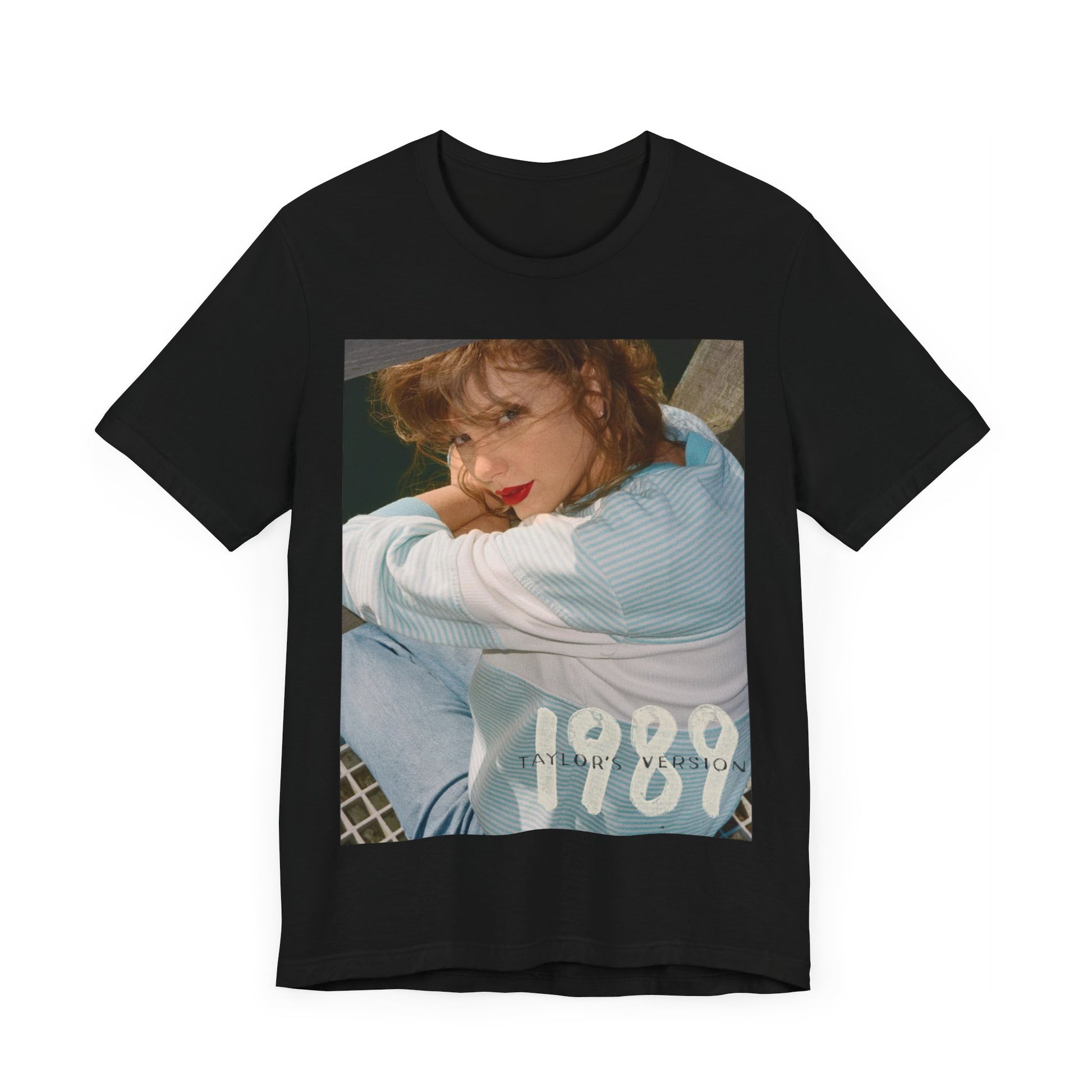A black graphic t-shirt featuring a 1989 aesthetic graphic of Taylor Swift.