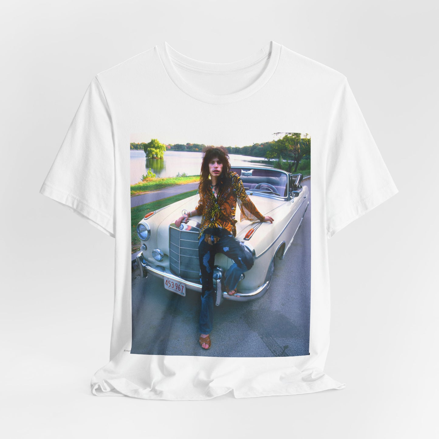 A black graphic t-shirt featuring a retro 70s photo of Aerosmith band members in a bohemian style, posing with a classic Mercedes car.