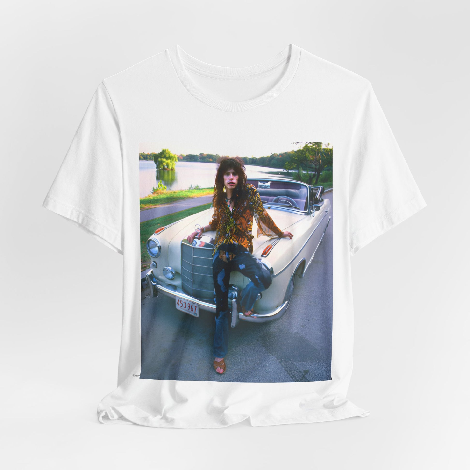 A black graphic t-shirt featuring a retro 70s photo of Aerosmith band members in a bohemian style, posing with a classic Mercedes car.