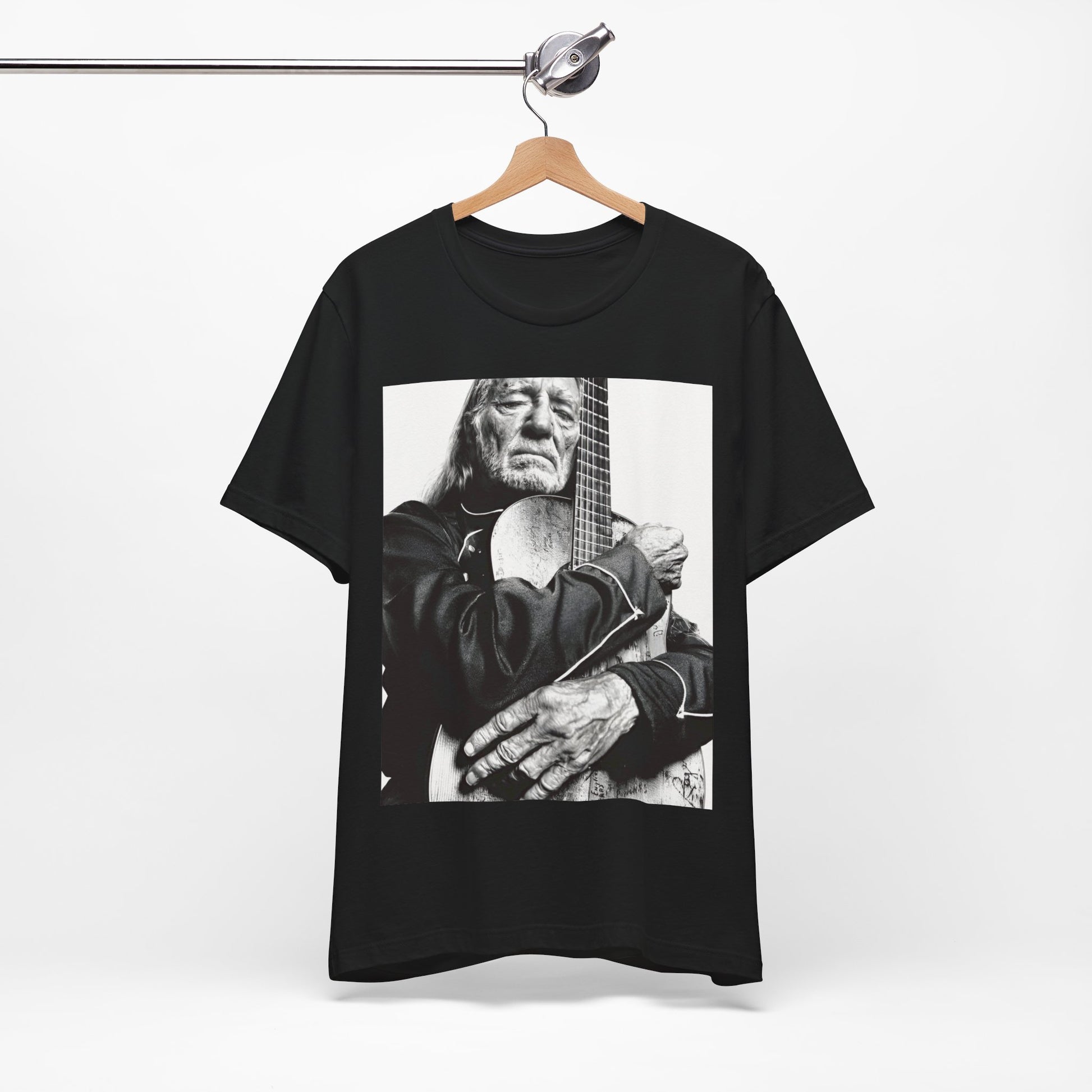 A black graphic t-shirt featuring a vintage country legend graphic of Willie Nelson.