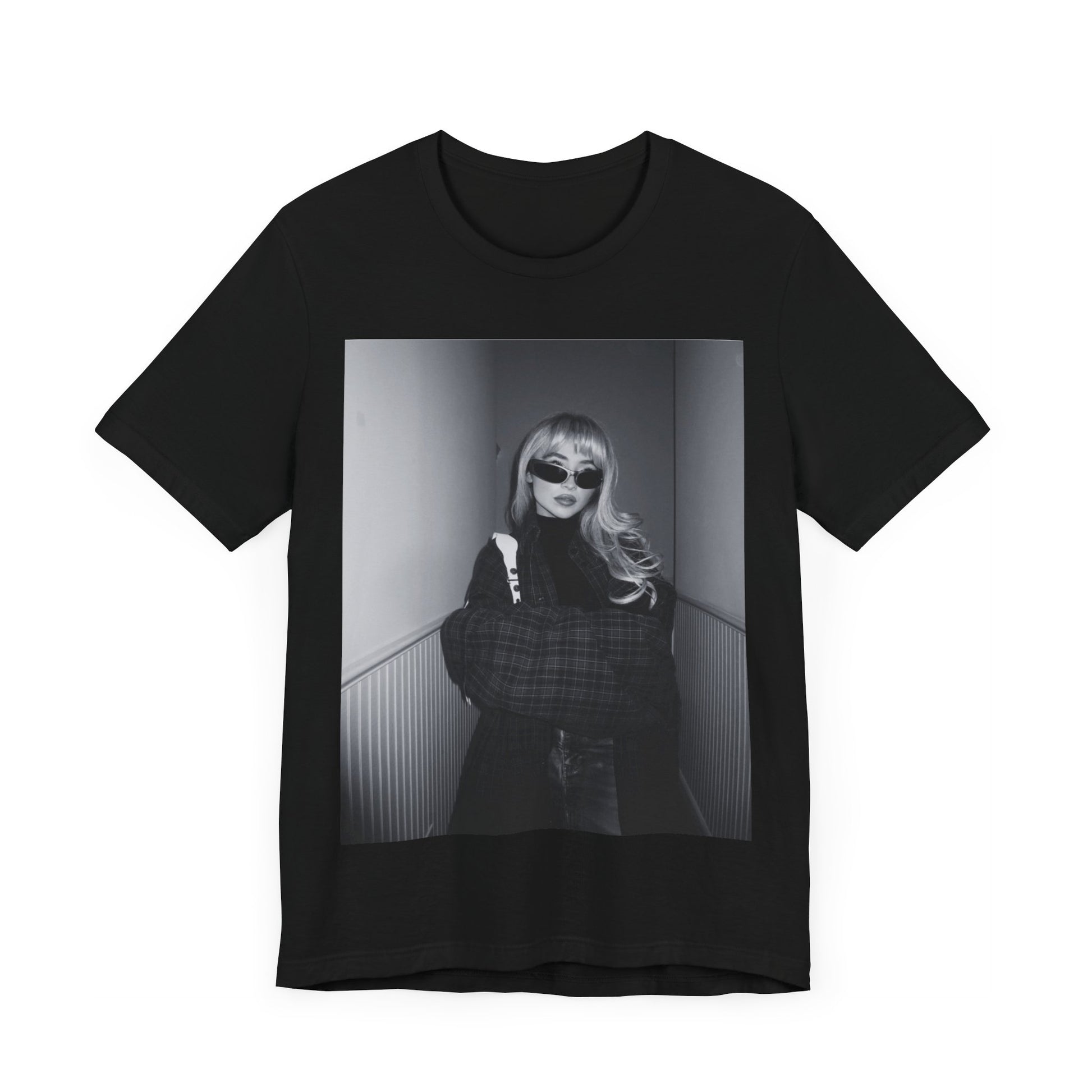 A black graphic t-shirt featuring a black and white glam pop diva graphic of Sabrina Carpenter.