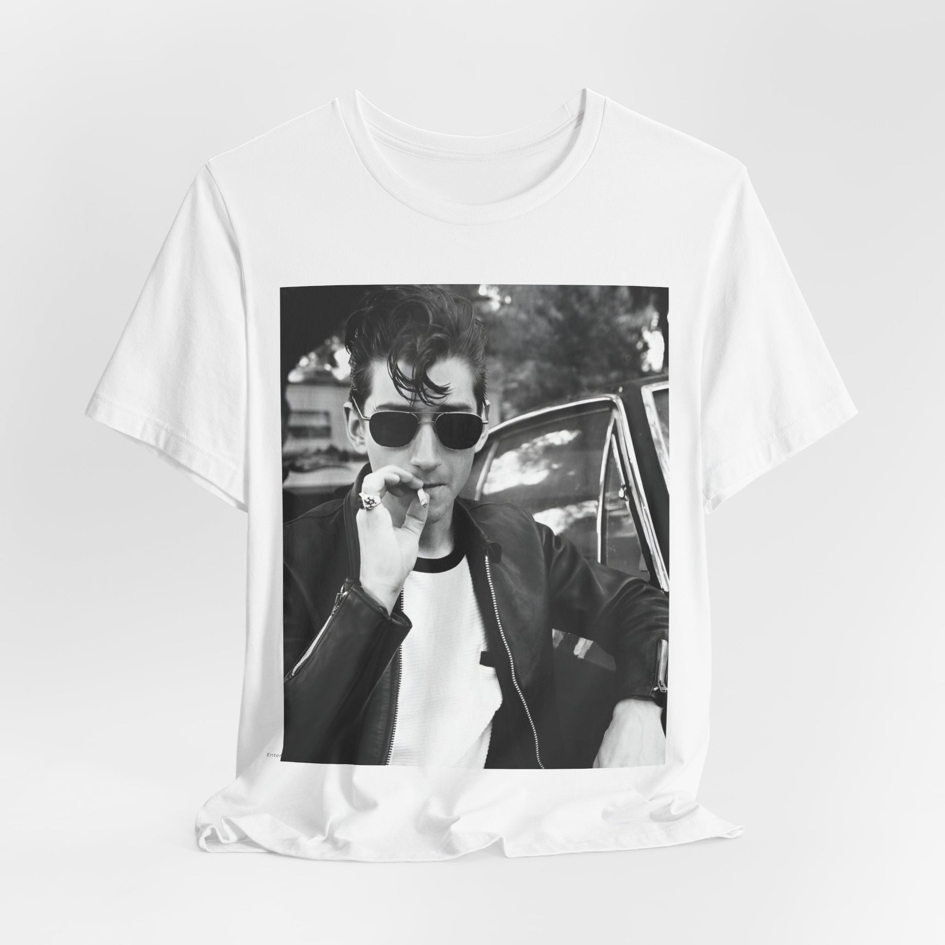 A black graphic t-shirt featuring a classic rock-style graphic of the Arctic Monkeys, possibly with band members in a stylized design.
