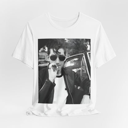 A black graphic t-shirt featuring a classic rock-style graphic of the Arctic Monkeys, possibly with band members in a stylized design.