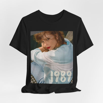 A black graphic t-shirt featuring a 1989 aesthetic graphic of Taylor Swift.