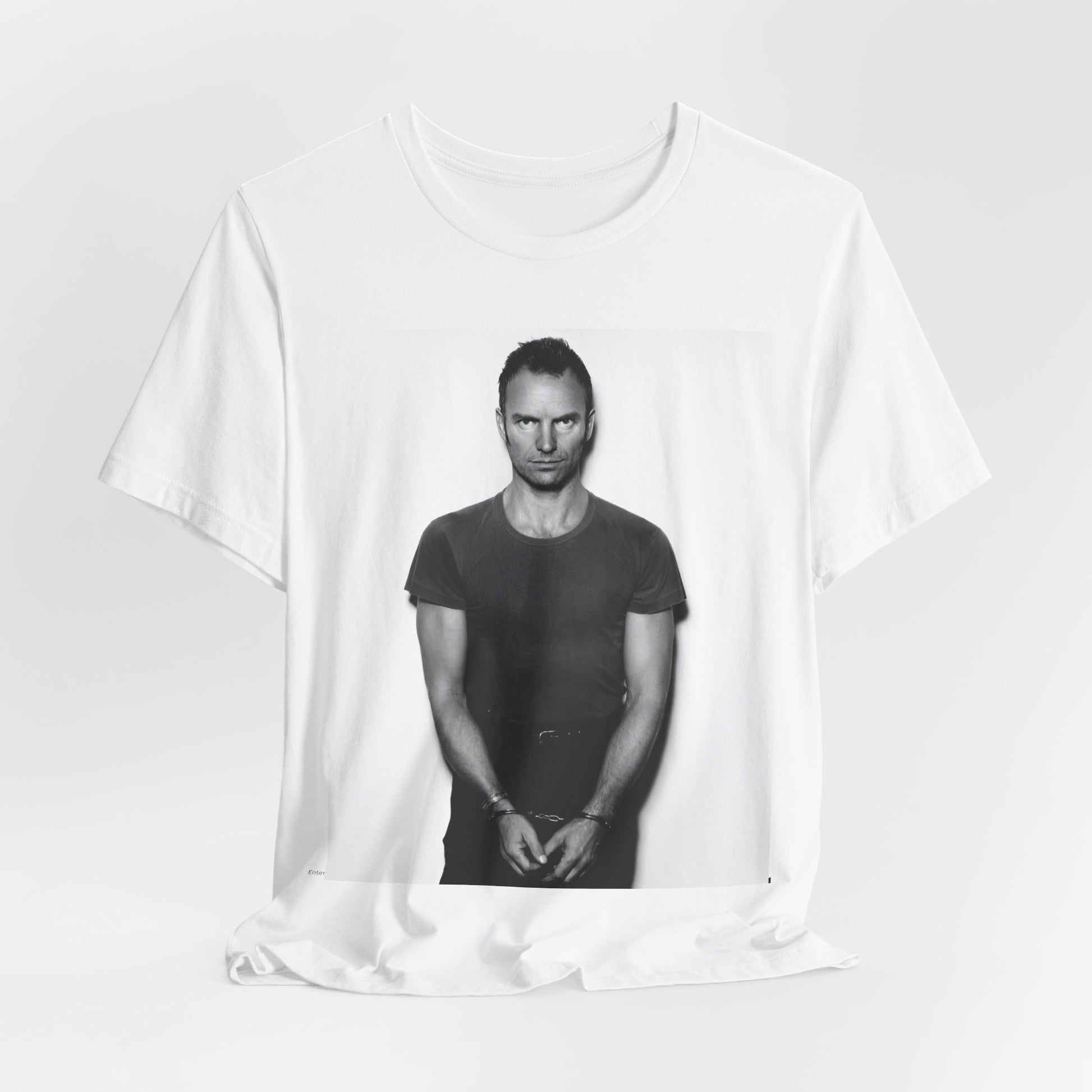 A black graphic t-shirt featuring a black and white portrait photo of Sting.