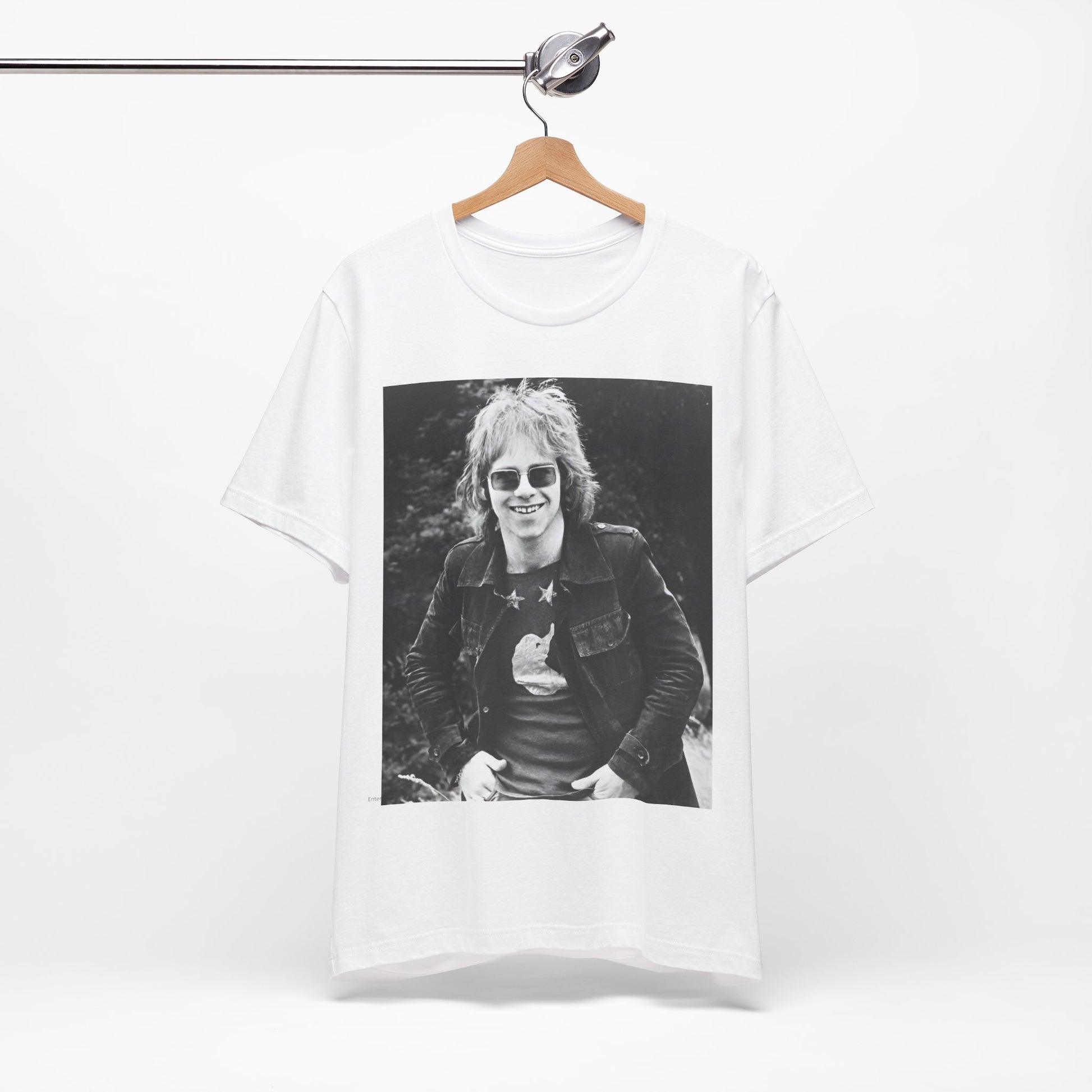 A black graphic t-shirt featuring a 70s black and white monochrome graphic or photo of Elton John.