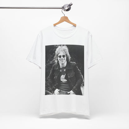 A black graphic t-shirt featuring a 70s black and white monochrome graphic or photo of Elton John.