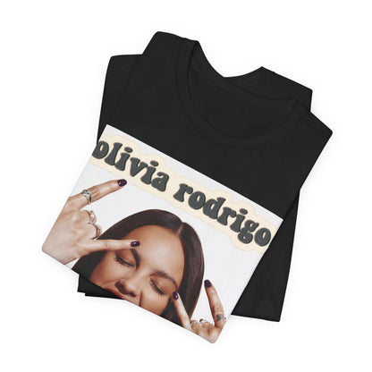 A black graphic t-shirt featuring a graphic related to Olivia Rodrigo's timeless pop anthems.