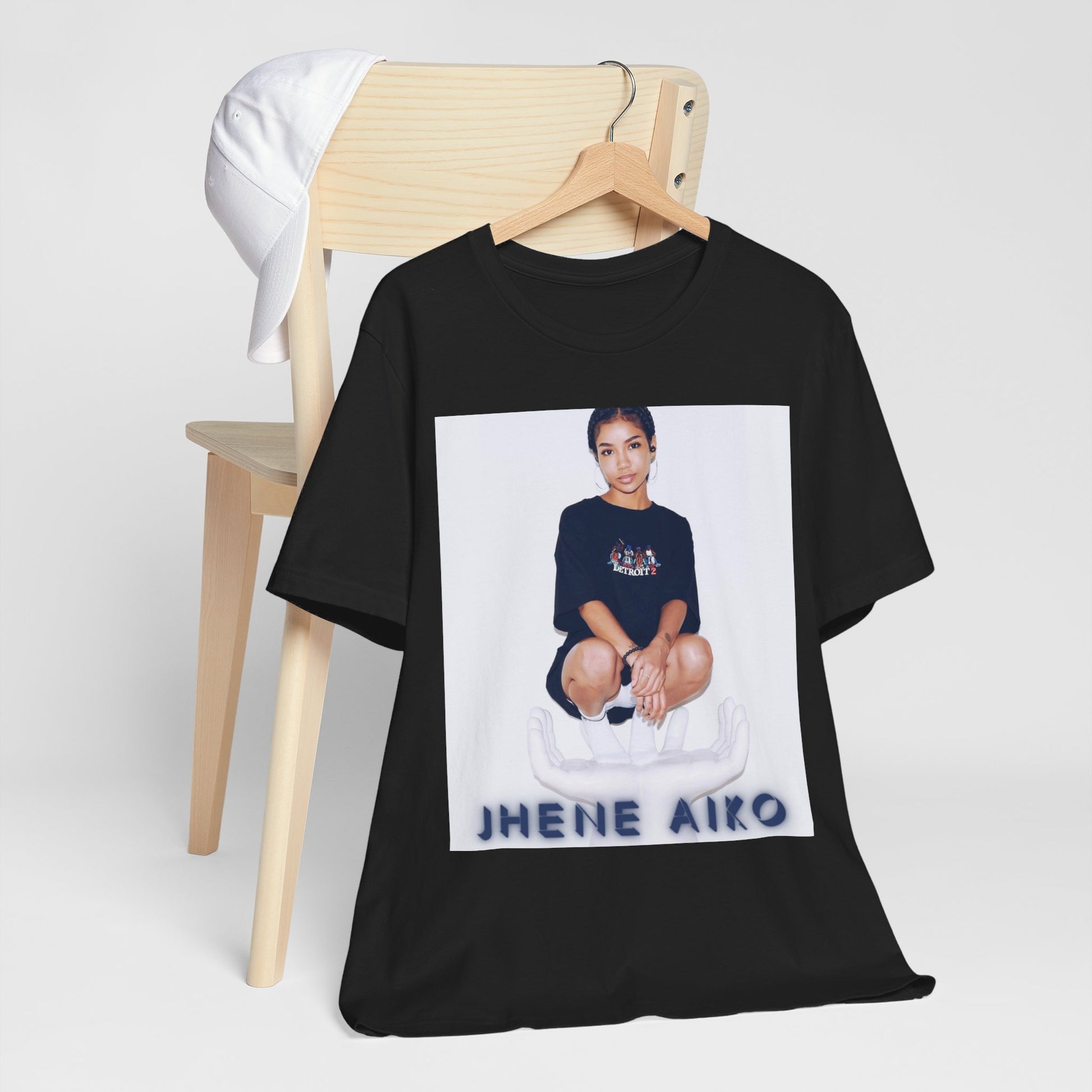 A black graphic t-shirt featuring a casual R&B fan graphic of Jhene Aiko.