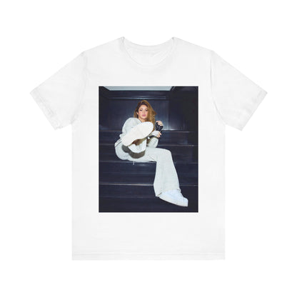 A black graphic t-shirt featuring a vintage Latin pop icon graphic of Shakira.