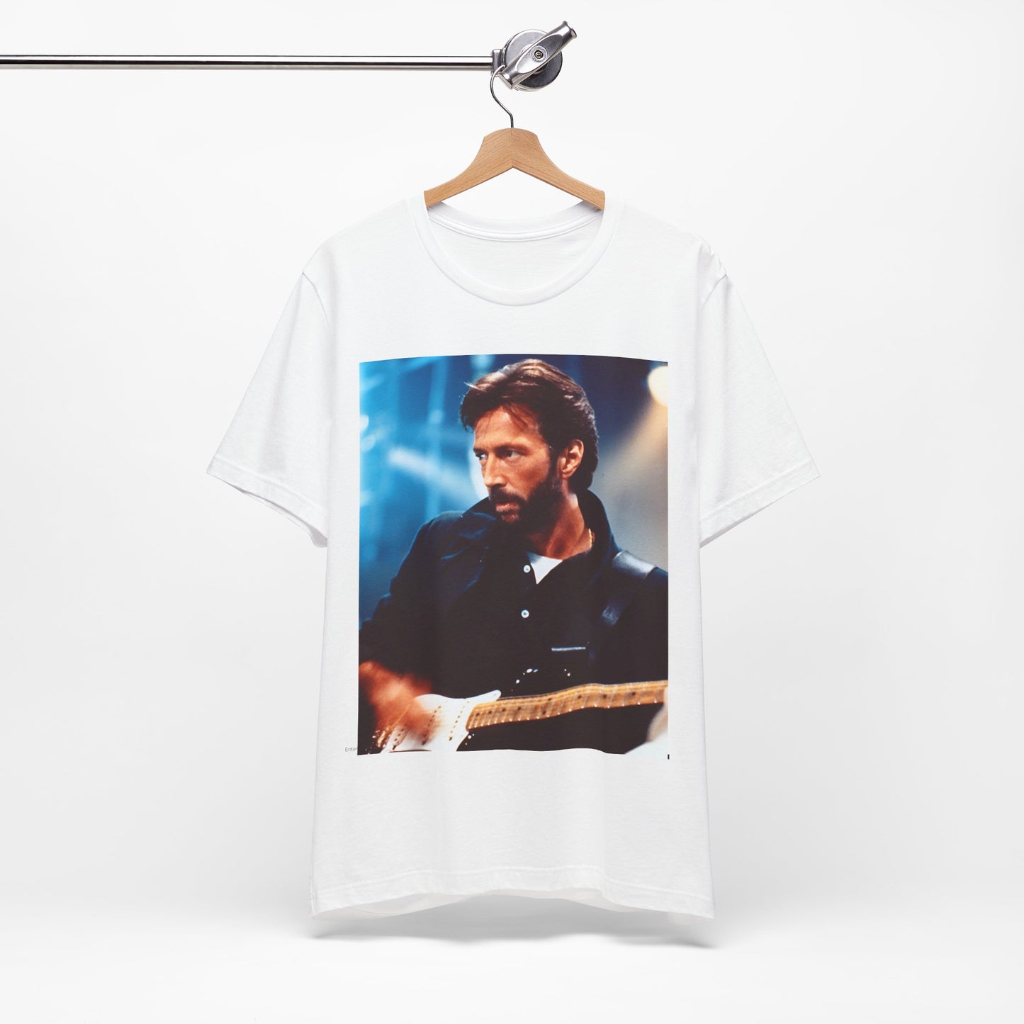 A black graphic t-shirt featuring a retro graphic or photo of Eric Clapton performing live on stage.