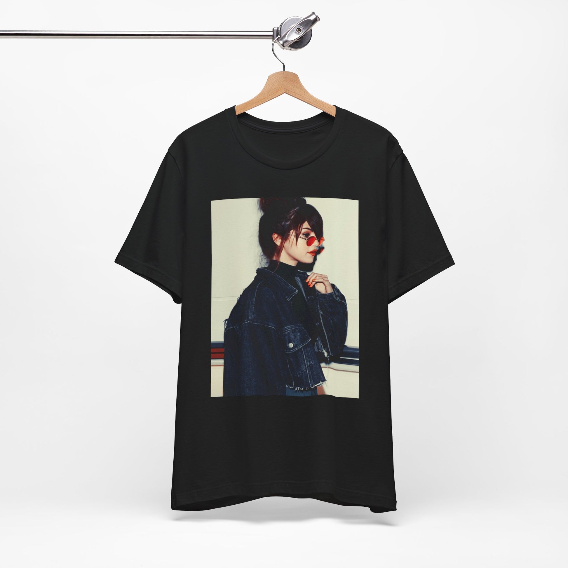 A black graphic t-shirt featuring a bold graphic of Selena Gomez as a pop superstar.