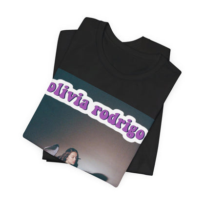 A black graphic t-shirt featuring a cool indie pop princess graphic of Olivia Rodrigo.