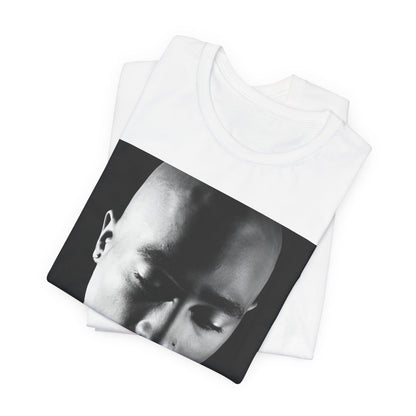 A black graphic t-shirt featuring a black and white streetwear rebel graphic of Tupac.