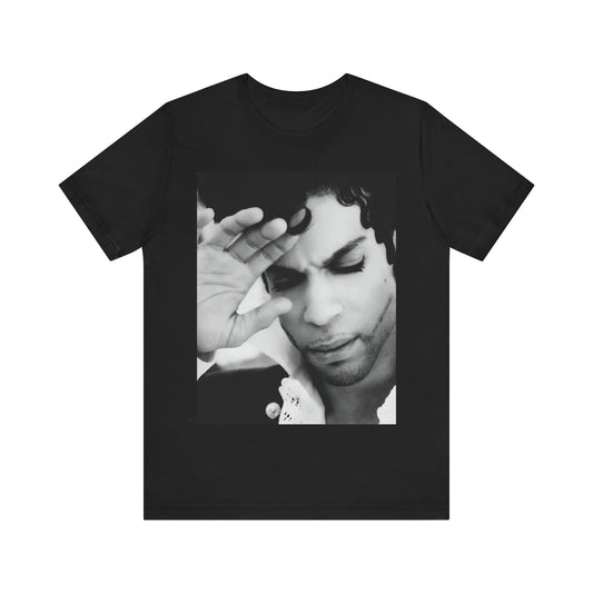 A black graphic t-shirt featuring a black and white graphic or photo portrait of Prince.