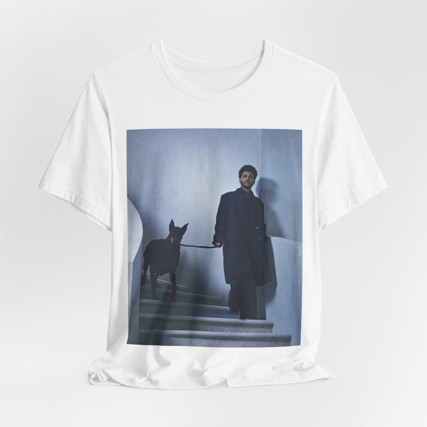 A black graphic t-shirt featuring a photo of The Weeknd with a doberman.