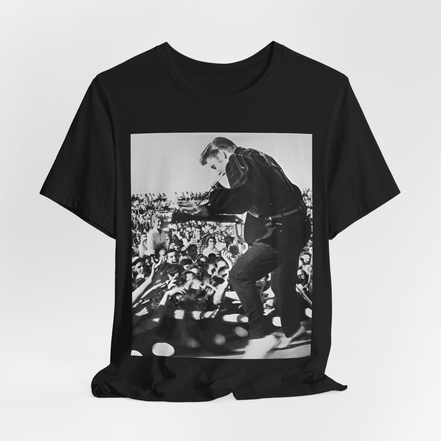 A black graphic t-shirt featuring a retro photo of Elvis Presley performing live in concert in the 1950s.