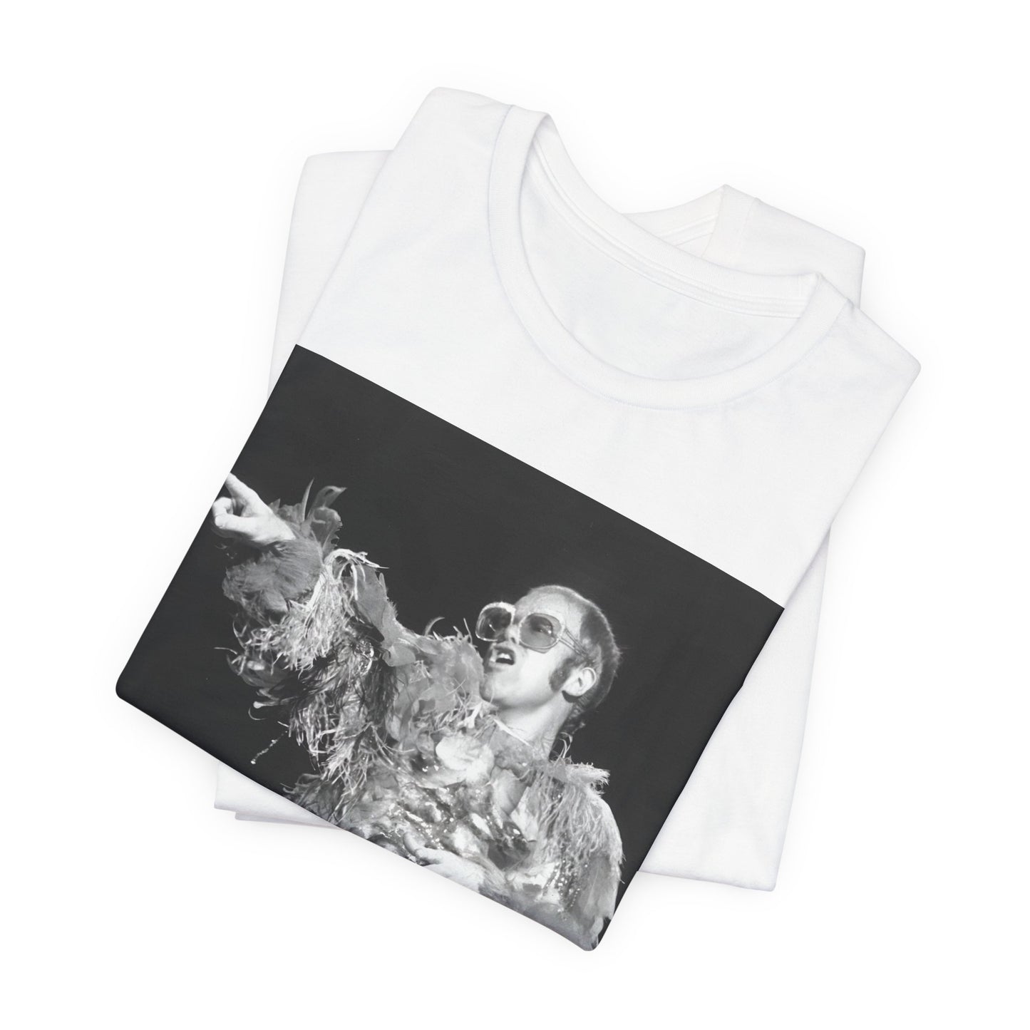 A black graphic t-shirt featuring a retro graphic of Elton John as a rock legend performing live.