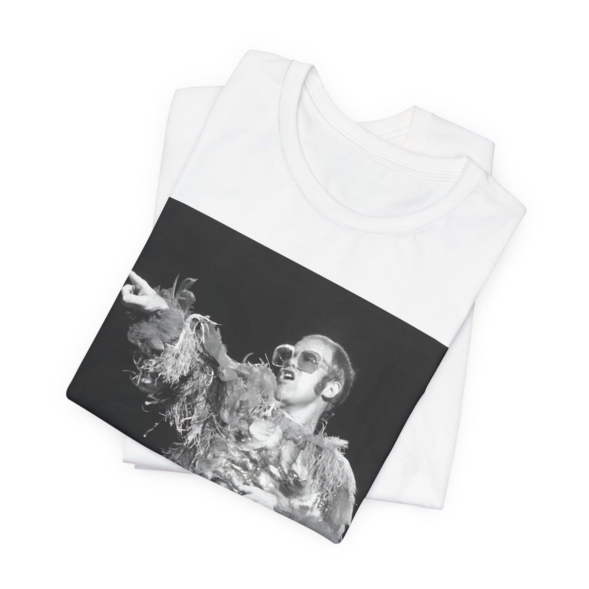 A black graphic t-shirt featuring a retro graphic of Elton John as a rock legend performing live.