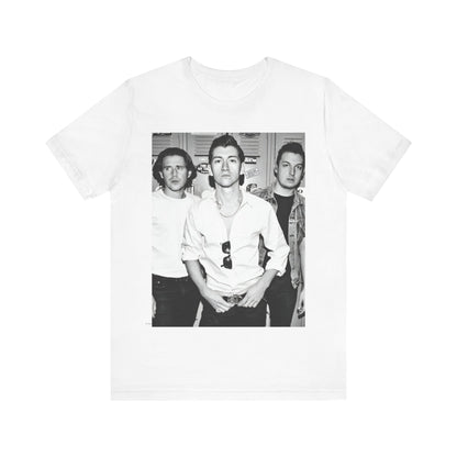 A black graphic t-shirt featuring a vintage-style design related to Arctic Monkeys' 'AM' album era, possibly with the album art or band imagery.