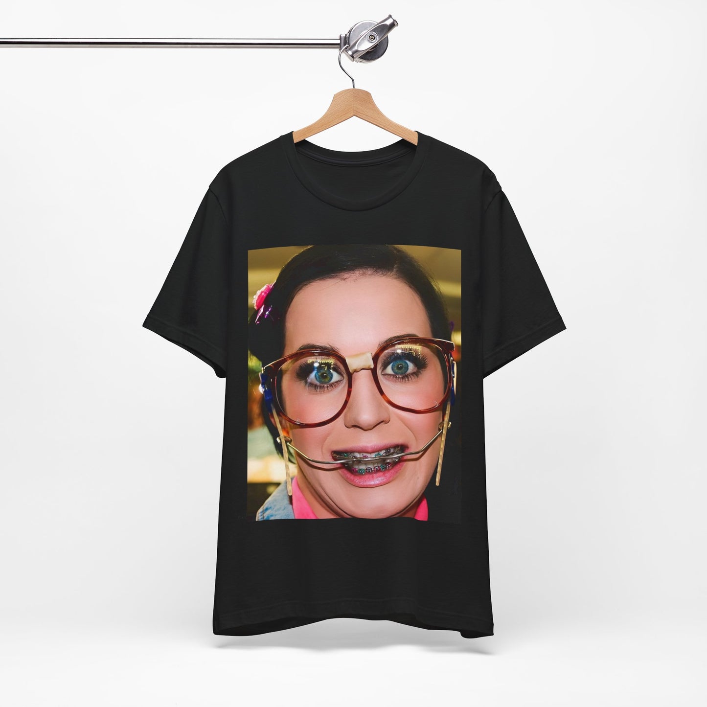 A black graphic t-shirt featuring a graphic related to Katy Perry's "I Kissed A Girl" song or era.