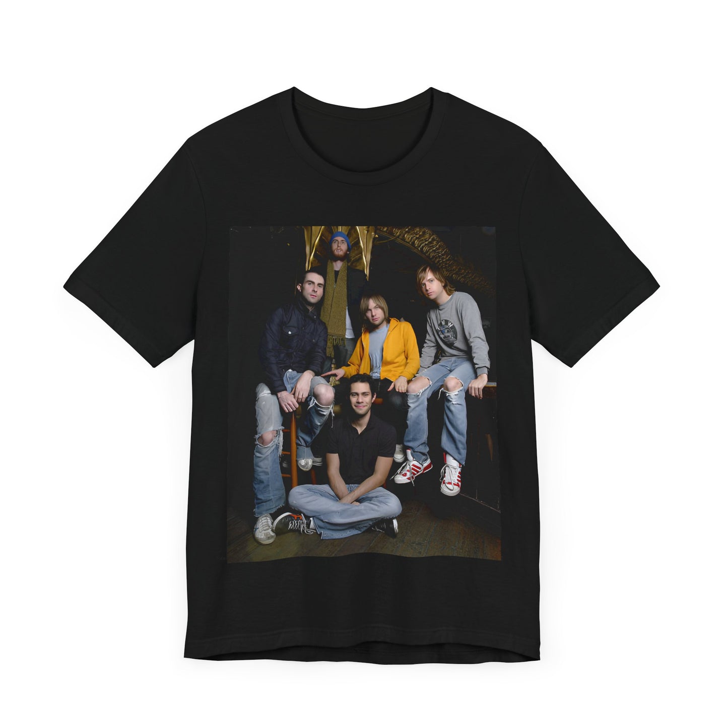 A high-energy, colorful photo of Maroon 5 performing live on stage at a concert, printed on a graphic t-shirt.