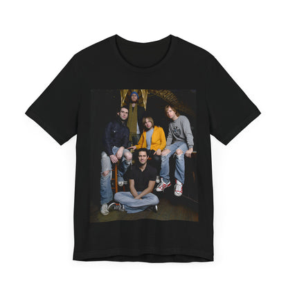 A high-energy, colorful photo of Maroon 5 performing live on stage at a concert, printed on a graphic t-shirt.
