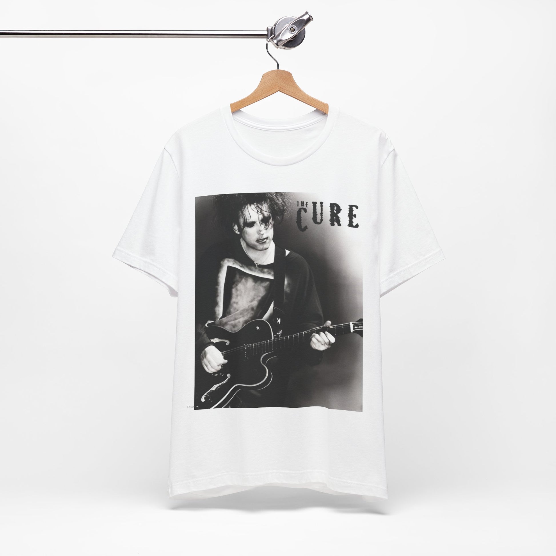 A black graphic t-shirt featuring a vintage goth rock graphic of The Cure.
