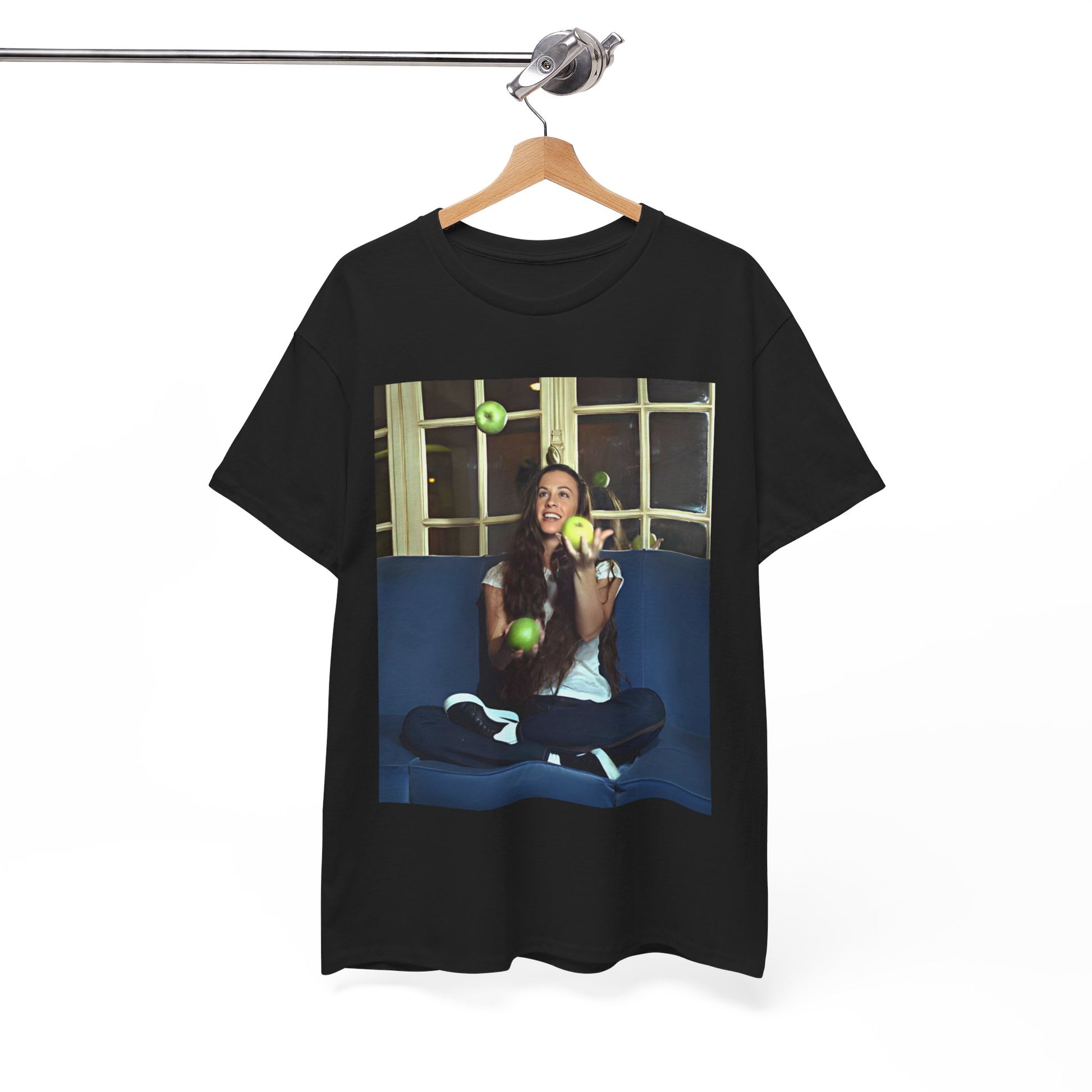 A black graphic t-shirt featuring a candid photo of Alanis Morissette sitting on a couch, looking relaxed or thoughtful.