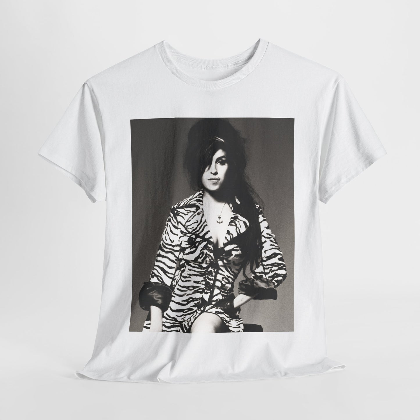 A black graphic t-shirt featuring a vintage black and white portrait of Amy Winehouse, showing her with her signature beehive and soulful expression.