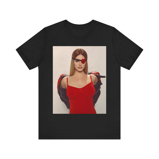 Conceptual photo of Lana Del Rey wearing a red, heart-shaped eyepatch and a leather jacket, printed on a graphic t-shirt.