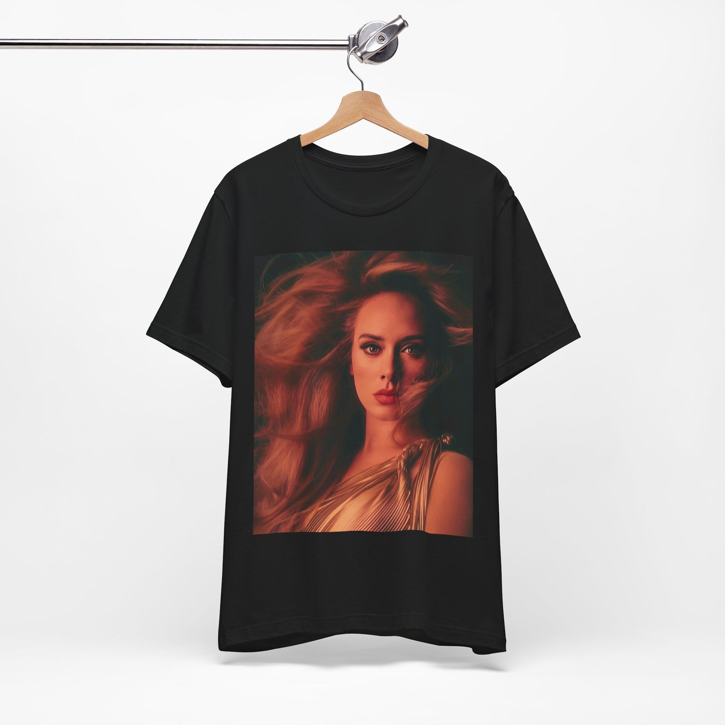 A black graphic t-shirt featuring a glamorous portrait of Adele wearing a golden gown, with voluminous hair, bathed in warm lighting, giving an editorial look.