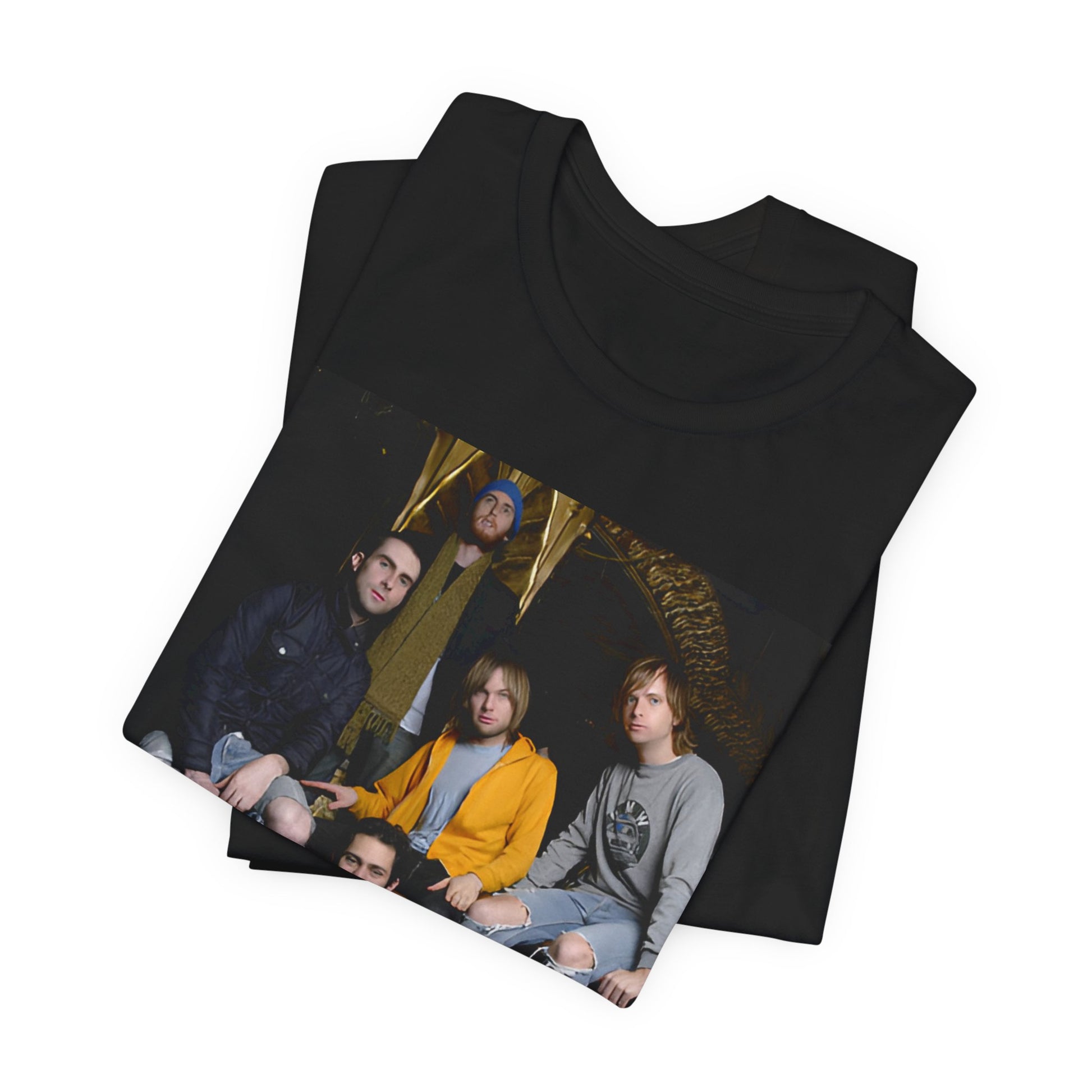 A high-energy, colorful photo of Maroon 5 performing live on stage at a concert, printed on a graphic t-shirt.