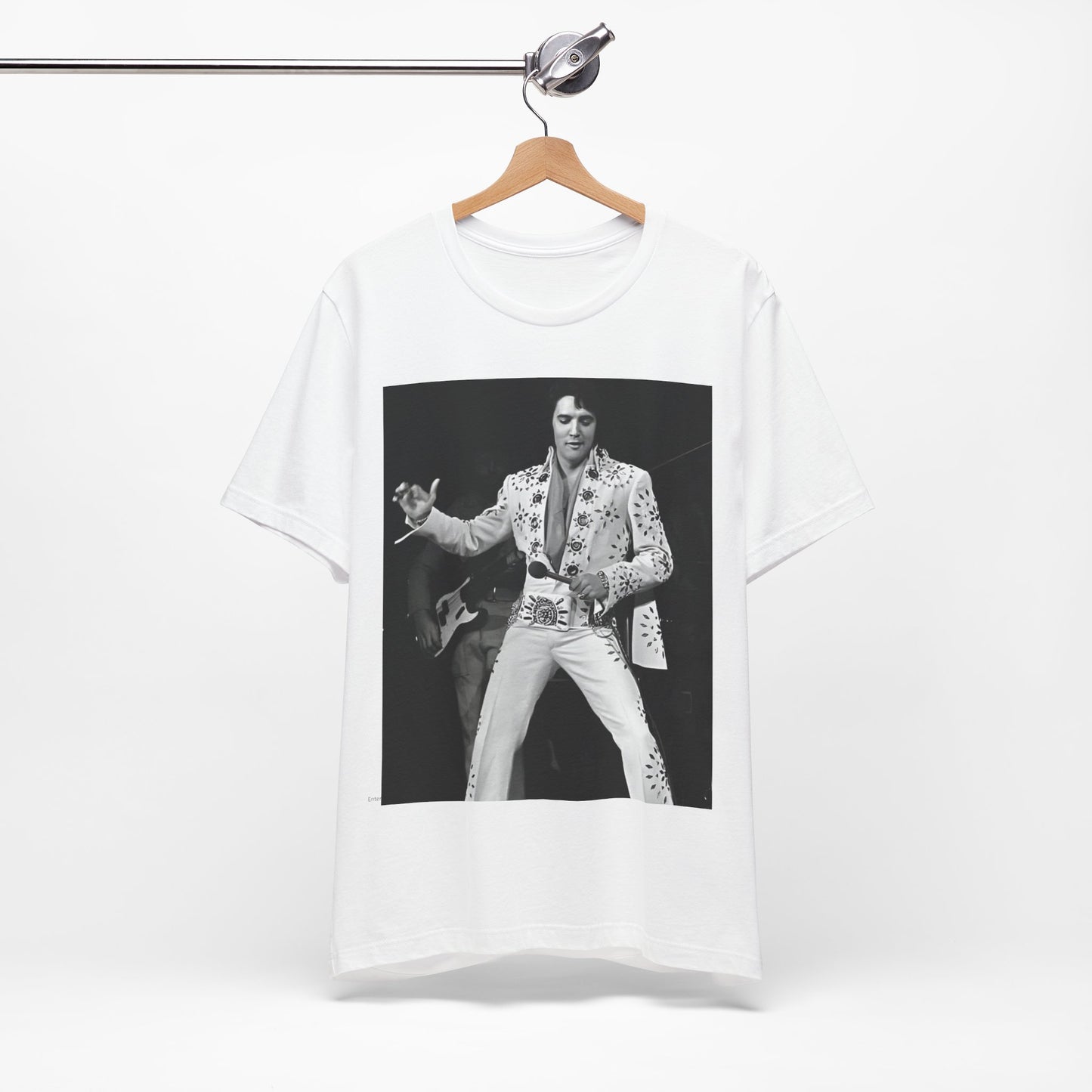 A black graphic t-shirt featuring a stylized graphic of Elvis Presley as The King of Rock 'n' Roll.