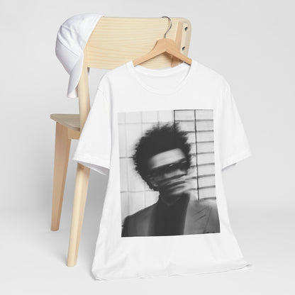 A black graphic t-shirt featuring a blurred graphic of The Weeknd from his 'After Hours' era.