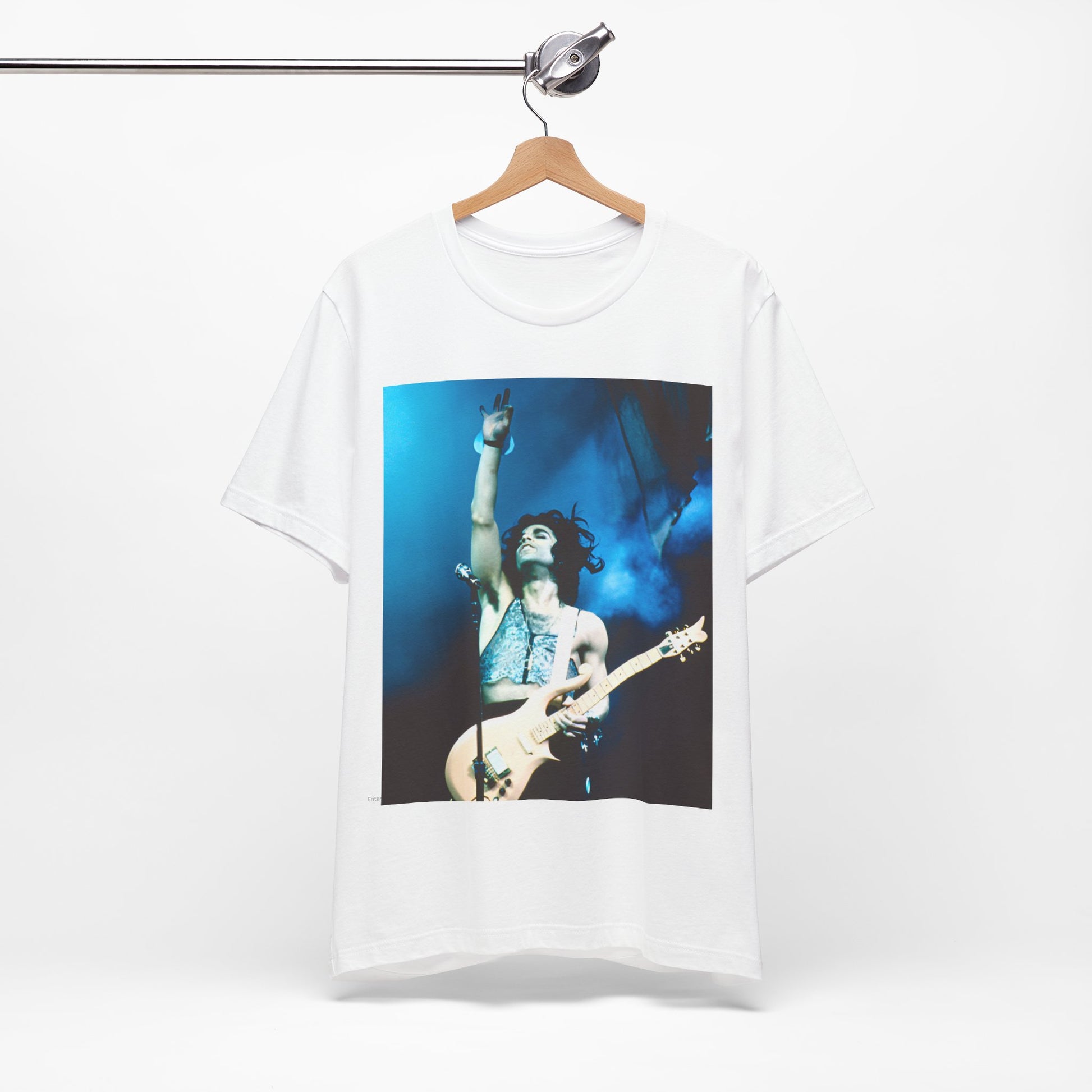 A black graphic t-shirt featuring a graphic of Prince as a guitar god and virtuoso performer.