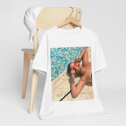 A black graphic t-shirt featuring a graphic of Rihanna in swimwear as a pop star queen.