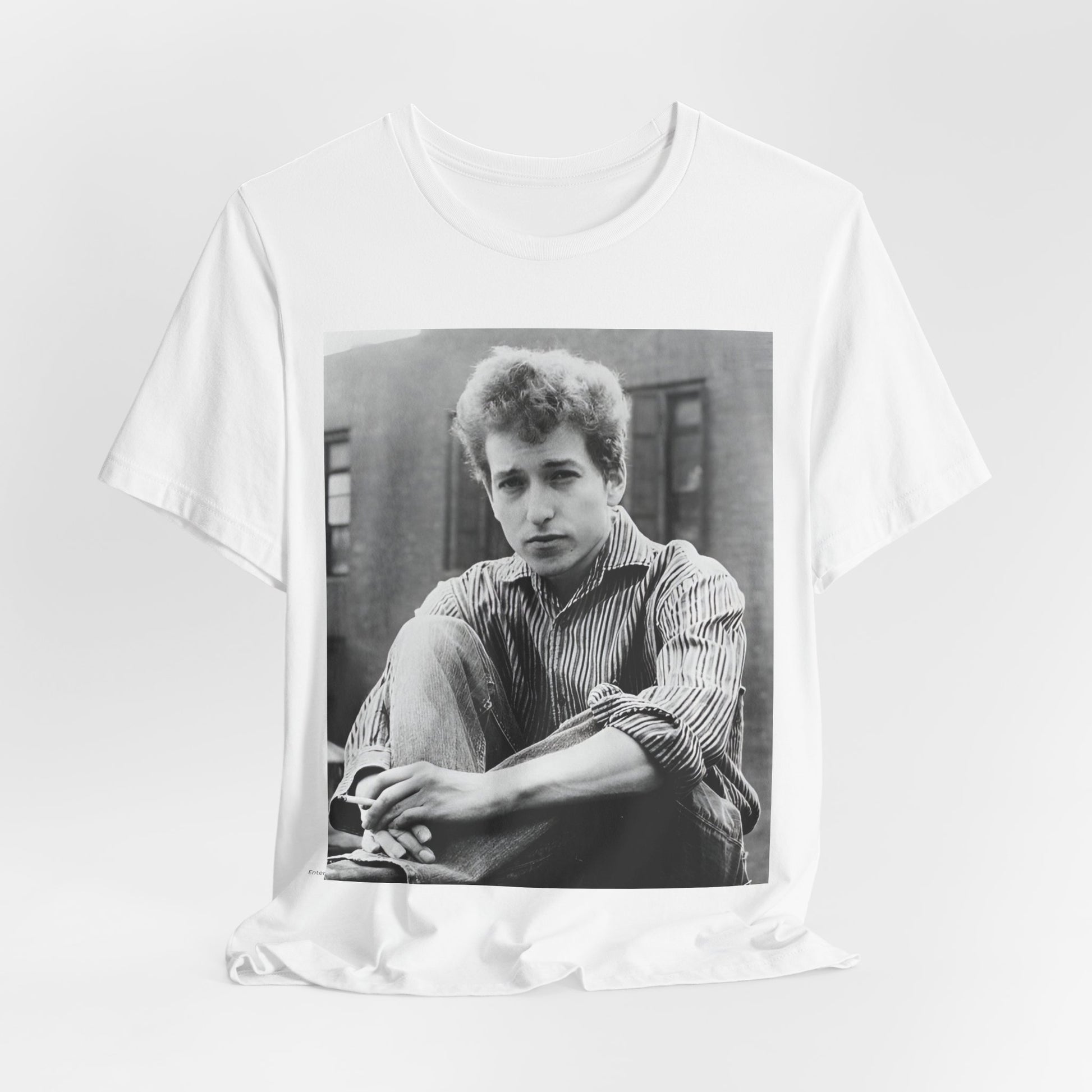 A black graphic t-shirt featuring a graphic of Bob Dylan from his 60s origins in folk music.