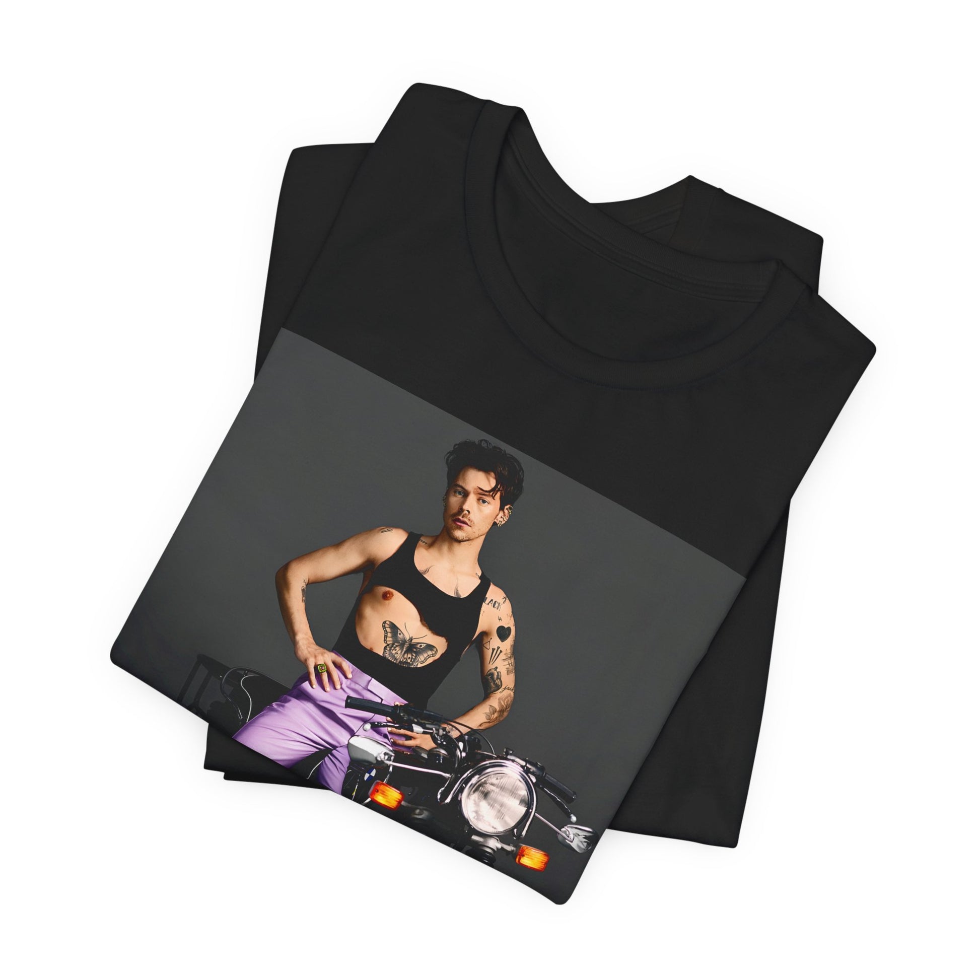 A black graphic t-shirt featuring a graphic of Harry Styles related to motorcycles or a rebellious, cool style.