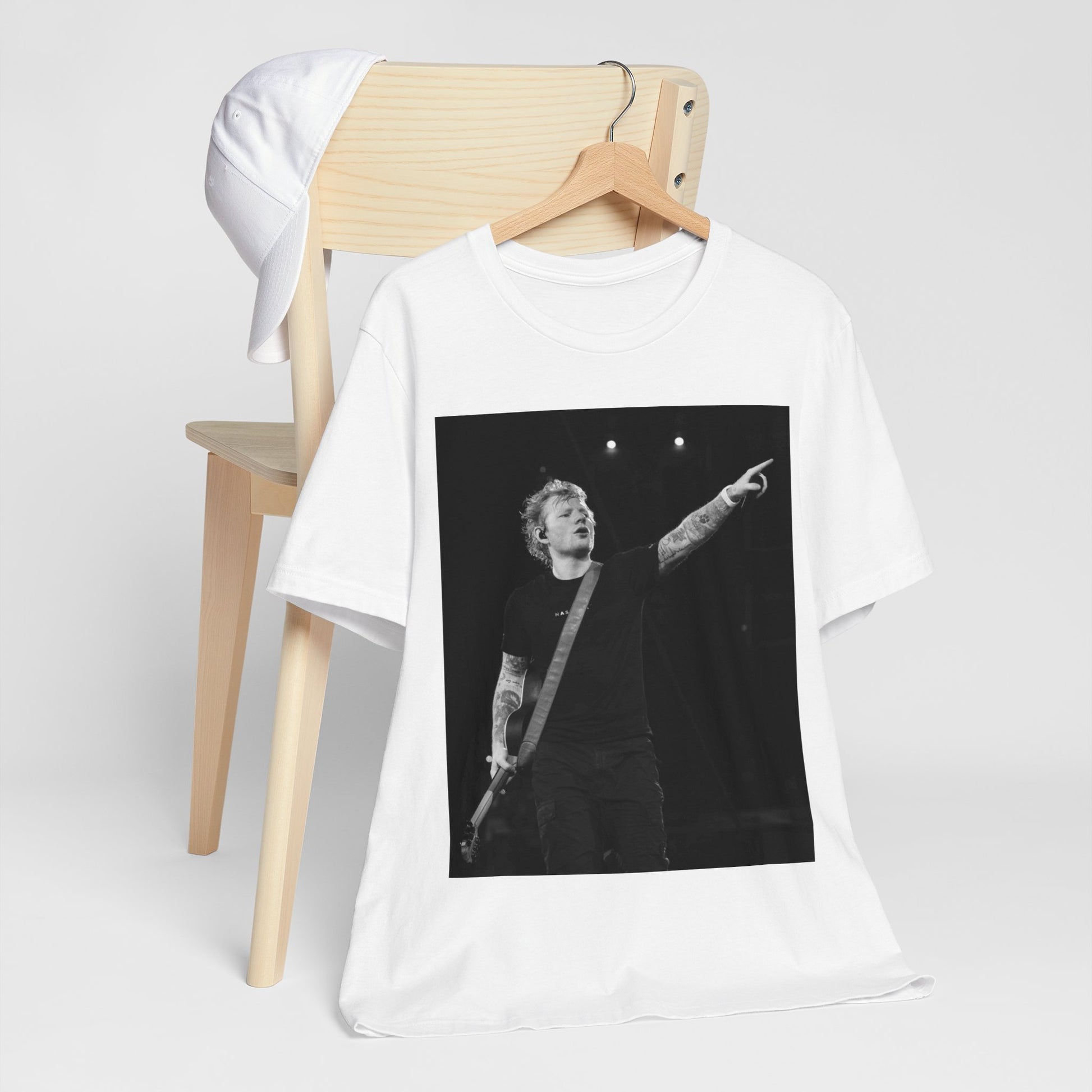 A black graphic t-shirt featuring a black and white graphic or photo of Ed Sheeran performing live on stage.