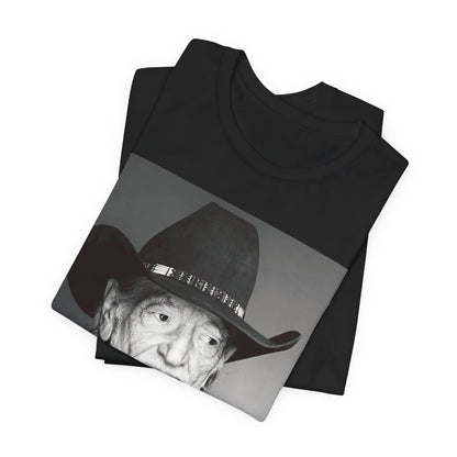 A black graphic t-shirt featuring a graphic of Willie Nelson with his iconic guitar 'Trigger'.