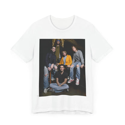A high-energy, colorful photo of Maroon 5 performing live on stage at a concert, printed on a graphic t-shirt.