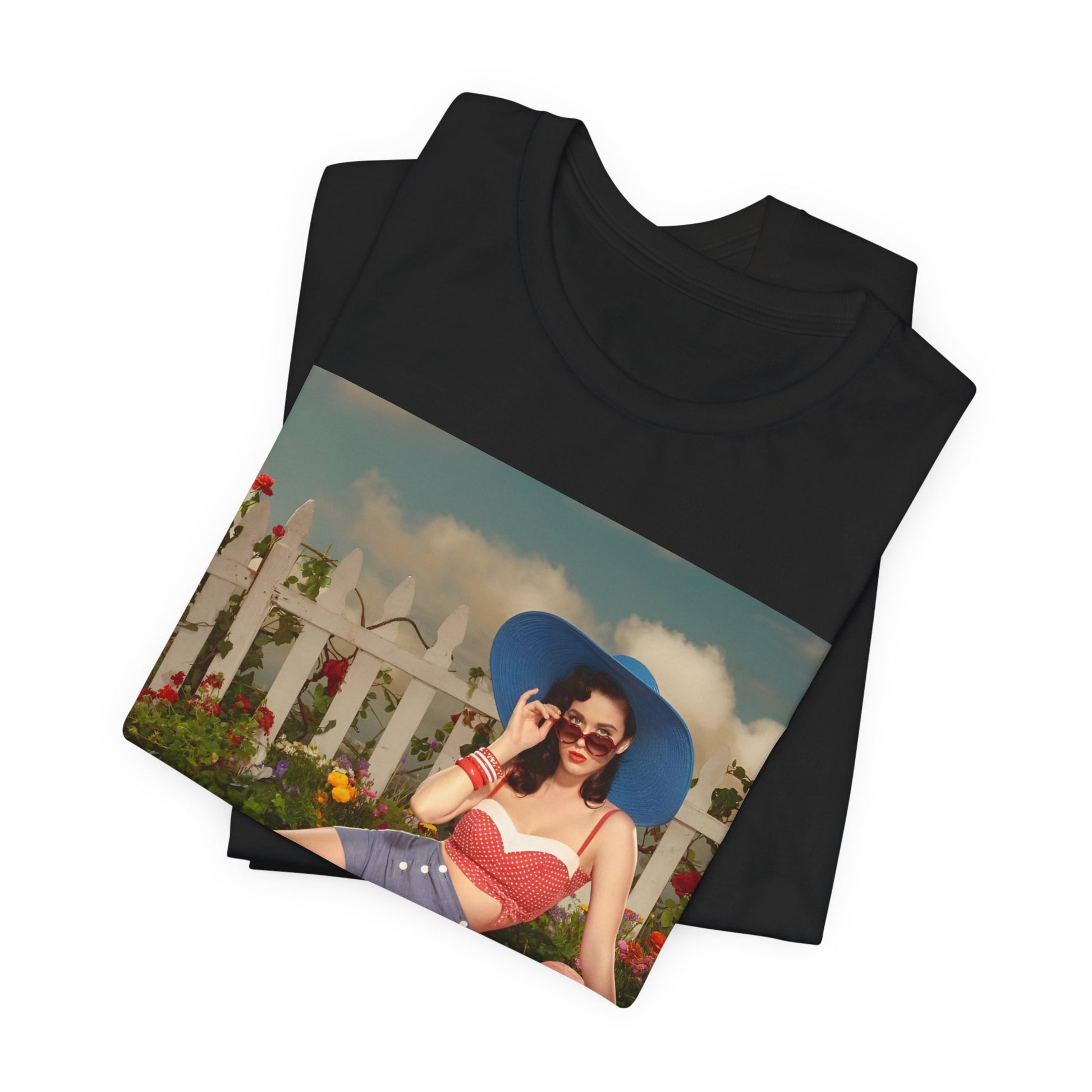 A black graphic t-shirt featuring a graphic related to Katy Perry's "California Gurls" song, with beach vibes.